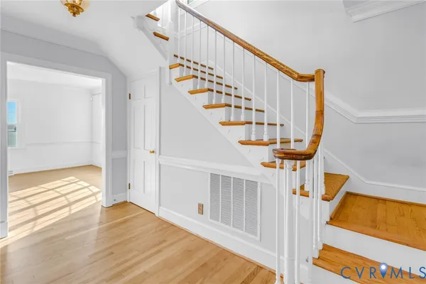 a bedroom with a bed a dresser and chair