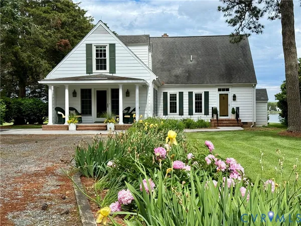 a view of an empty room with a window and fire place