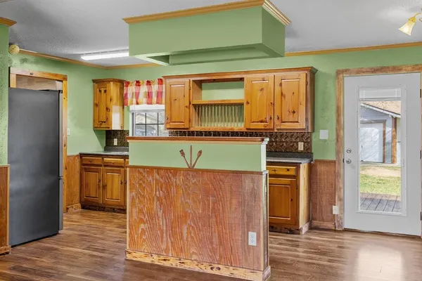 a kitchen with stainless steel appliances granite countertop a refrigerator and a sink