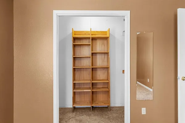 a view of walk in closet with empty racks