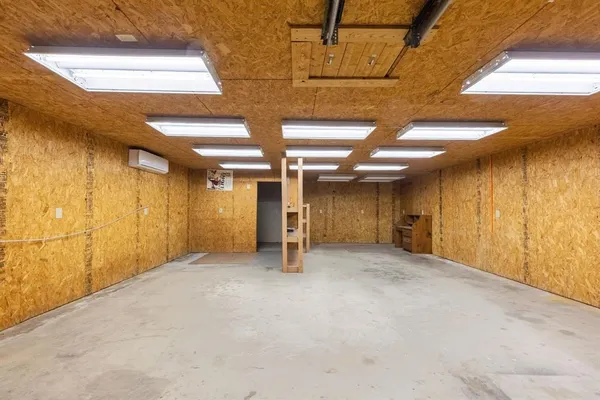a view of empty room with wooden walls