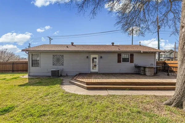 a view of a house with a backyard and a tree