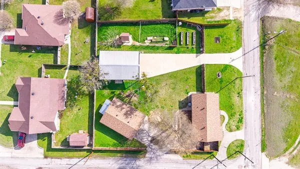 an aerial view of a houses with yard