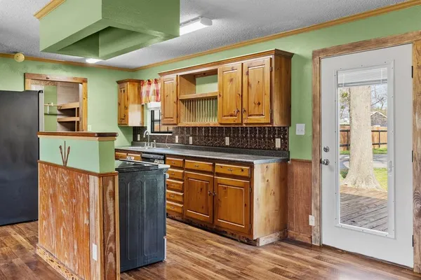 a kitchen with granite countertop a stove and a refrigerator