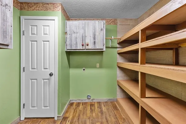 a view of walk in closet with wooden floor