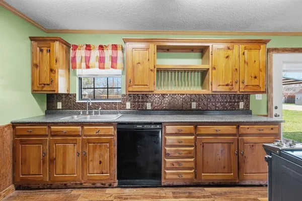 a kitchen with stainless steel appliances granite countertop a sink and cabinets