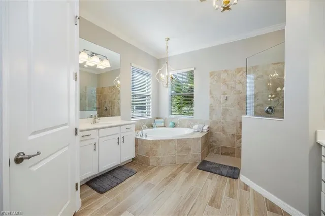 a spacious bathroom with a bathtub sink and mirror