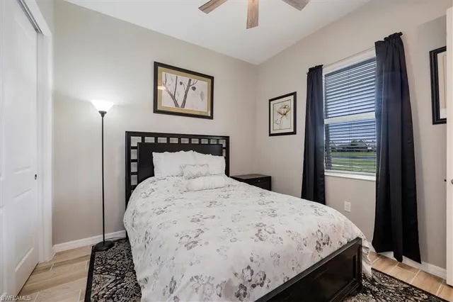a bedroom with a large bed and a window
