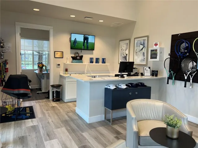 a living room with lots of furniture and a large window