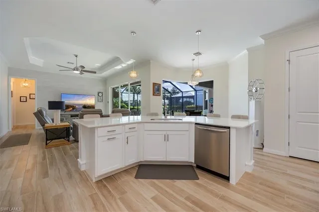 a kitchen with white cabinets and sink