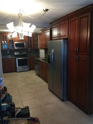 a kitchen with cabinets and stainless steel appliances