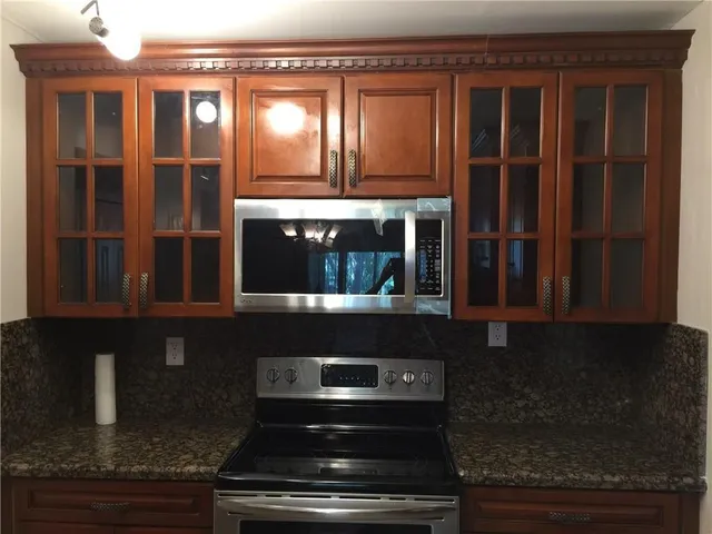 a kitchen with granite countertop stainless steel appliances and cabinets