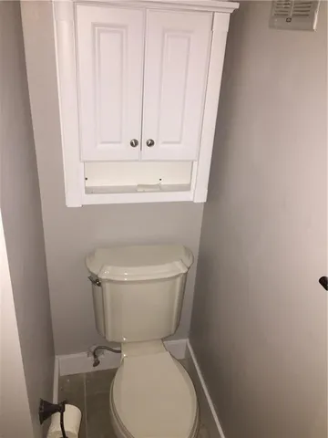 a white toilet sitting next to a sink