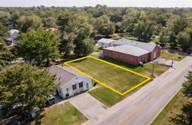 an aerial view of a tennis ground and a large pool