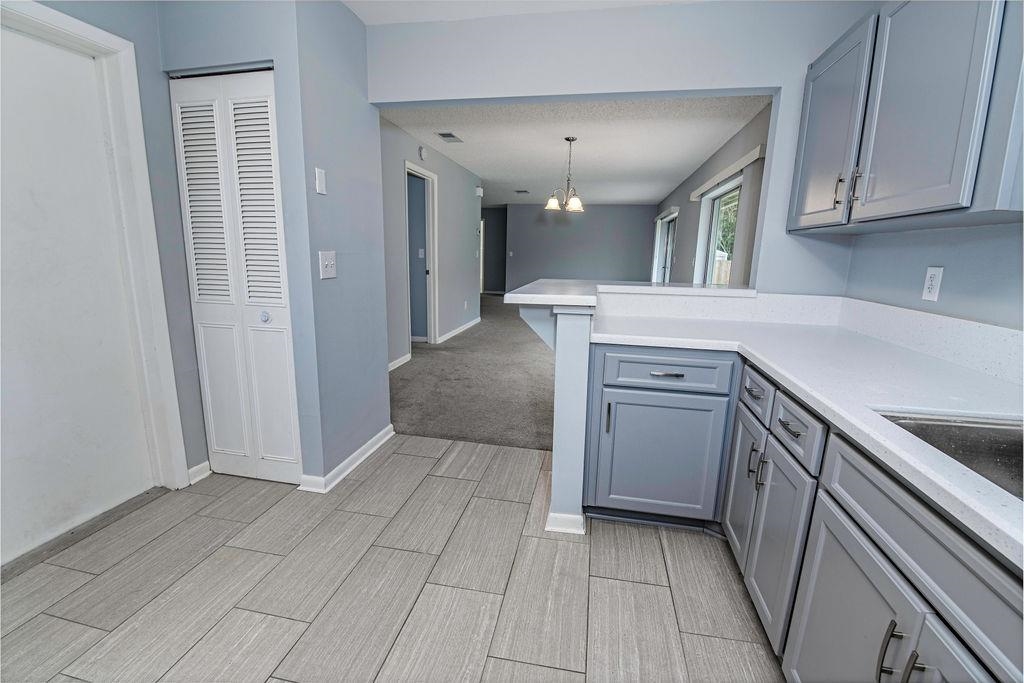 1061 Mindello Avenue St. Augustine, FL 32086 - Photo 12 of 26 a kitchen with a sink a stove and cabinets