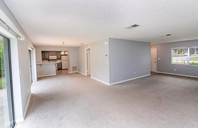 a view of a kitchen with a refrigerator and a sink
