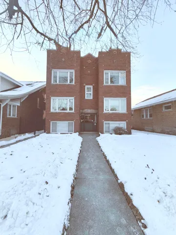 a view of a building with a snow on the road