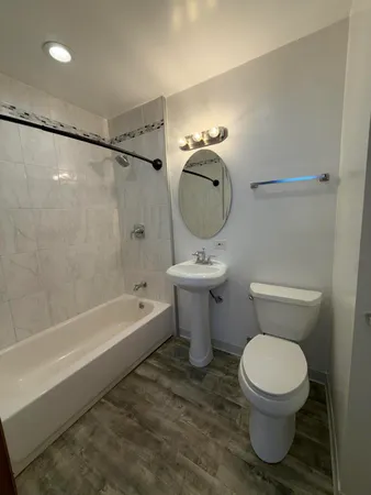 a bathroom with a toilet a sink and a shower