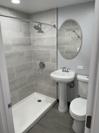 a bathroom with a sink toilet and shower