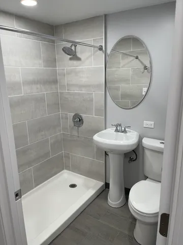 a bathroom with a sink toilet and shower