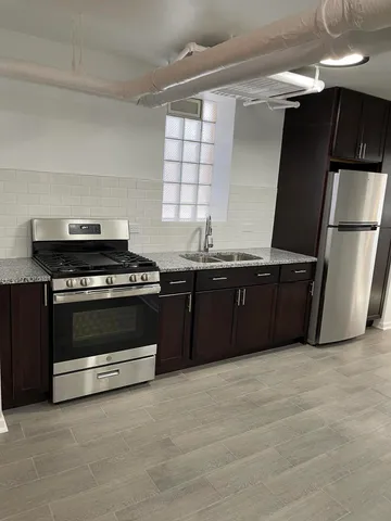 a kitchen with stainless steel appliances a stove and a refrigerator