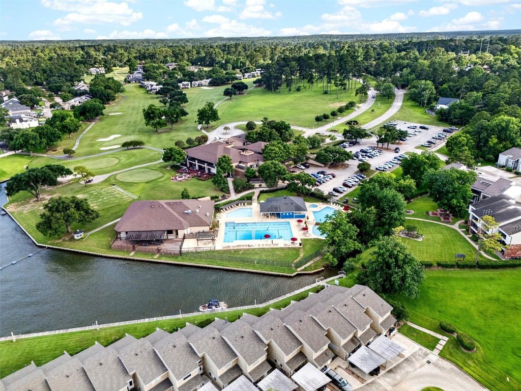17 April Point Drive North Conroe, TX 77356 - Photo 42 of 42 an aerial view of a house with a garden and lake view