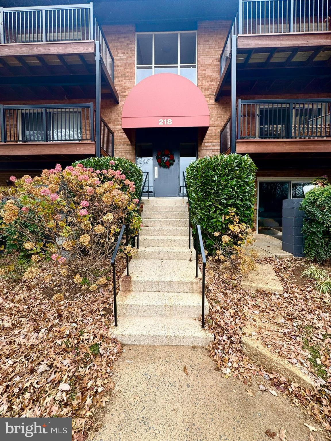218 Locust Street Southeast, Unit 143 Vienna, VA 22180 - Photo 1 of 14 a front view of a house with garden