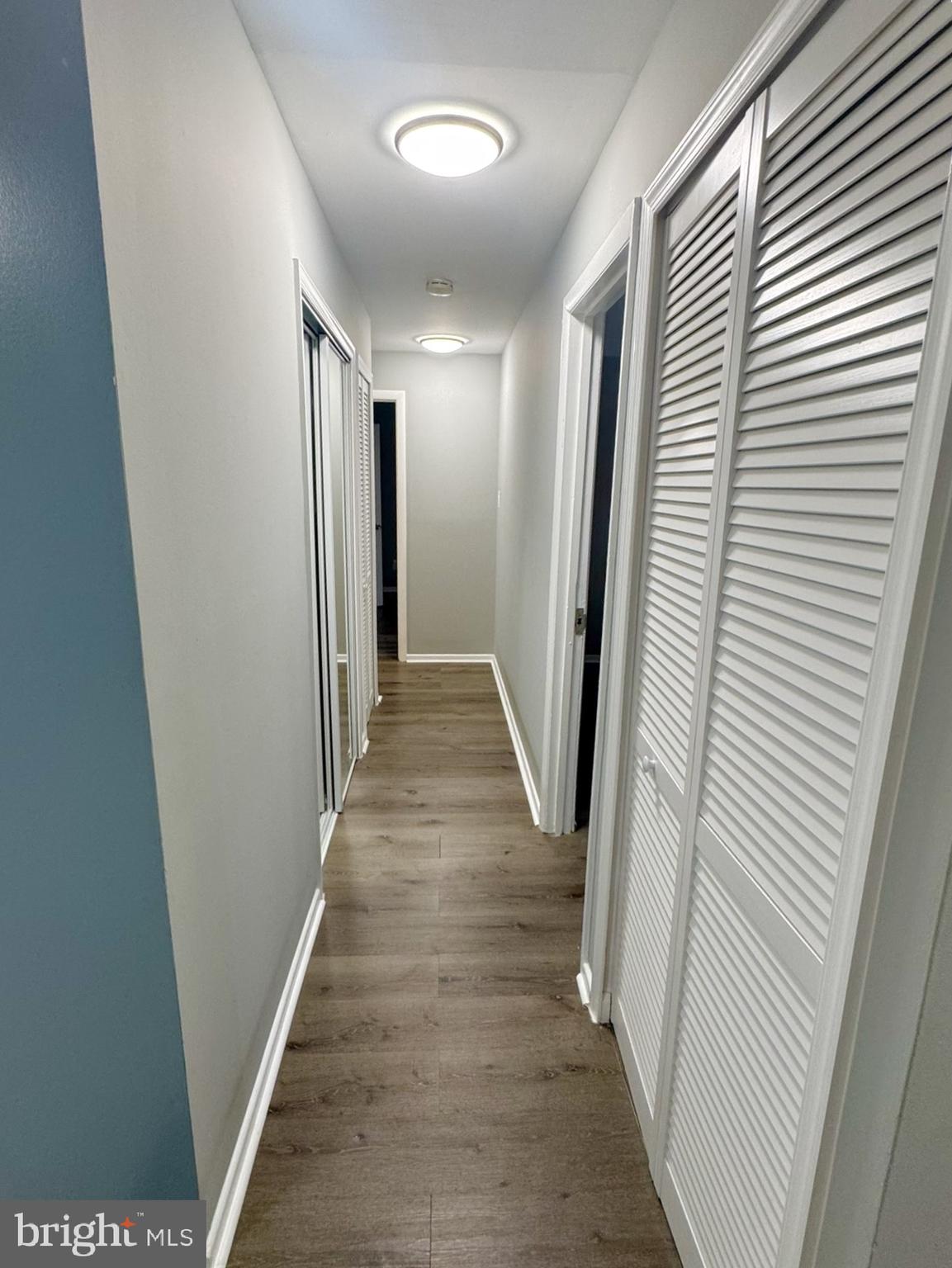 218 Locust Street Southeast, Unit 143 Vienna, VA 22180 - Photo 6 of 14 a view of a hallway with wooden floor and staircase