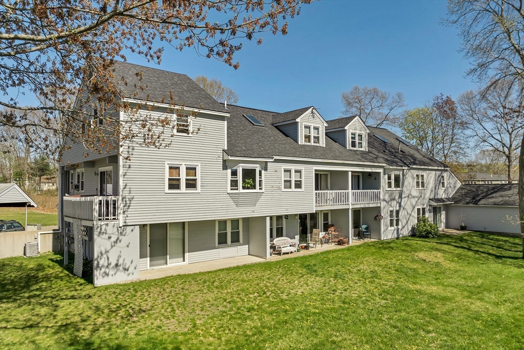 a front view of a house with a garden and yard
