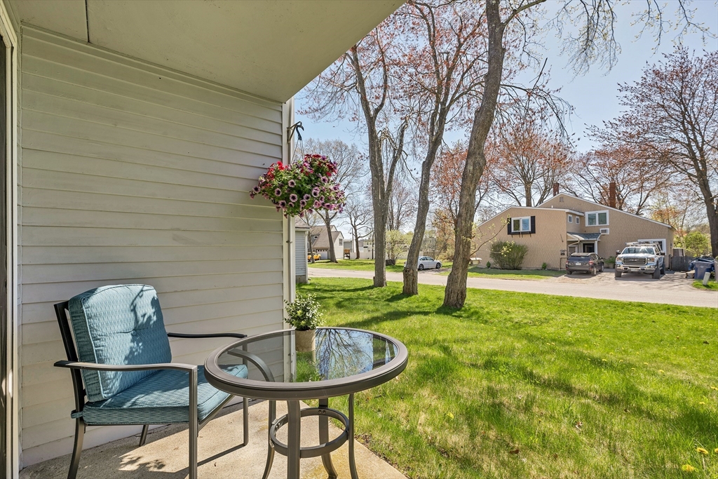 64 Esker Road, Unit 2 Hampton, NH 03842 - Photo 17 of 35 a backyard of a house with table and chairs