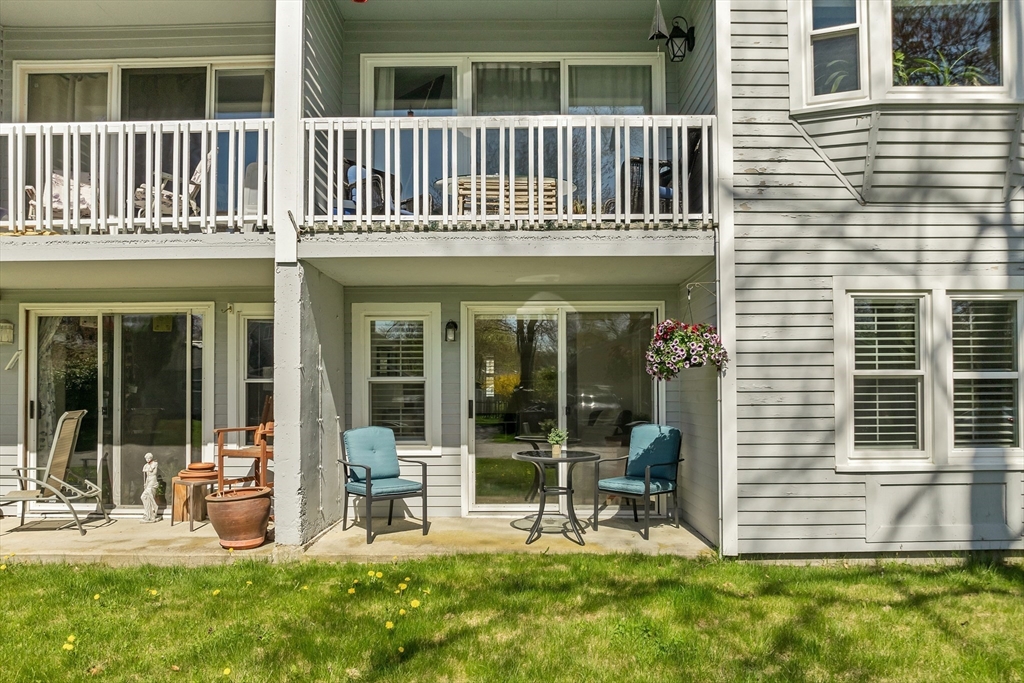64 Esker Road, Unit 2 Hampton, NH 03842 - Photo 20 of 35 a view of a house with chairs and a yard