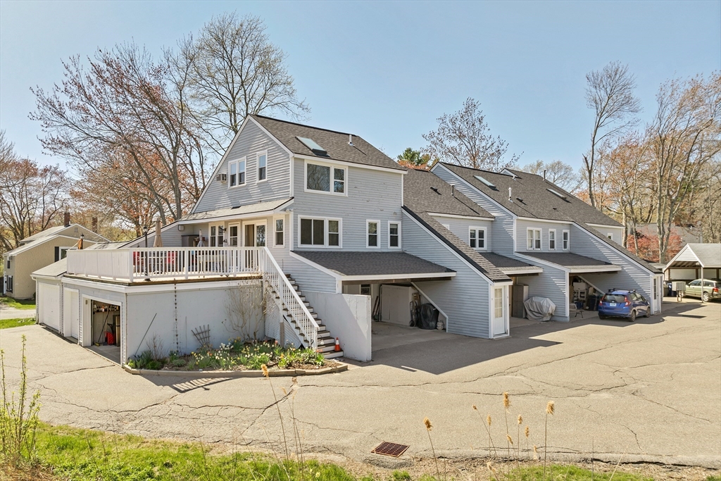 64 Esker Road, Unit 2 Hampton, NH 03842 - Photo 25 of 35 a front view of a house with a yard