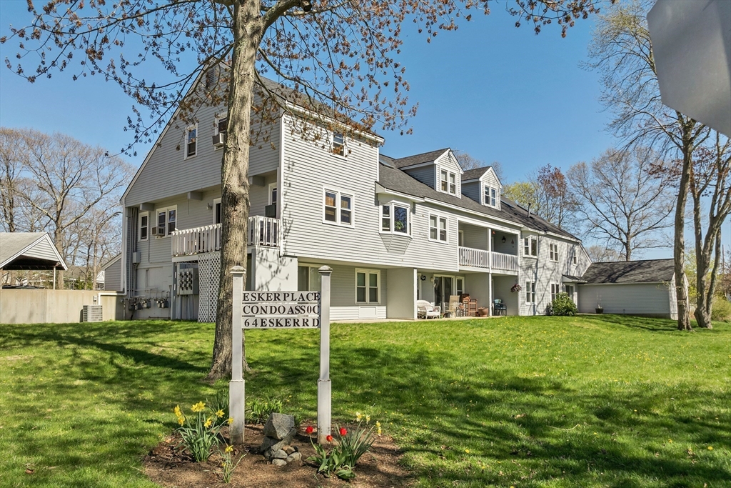64 Esker Road, Unit 2 Hampton, NH 03842 - Photo 26 of 35 a front view of a building with garden