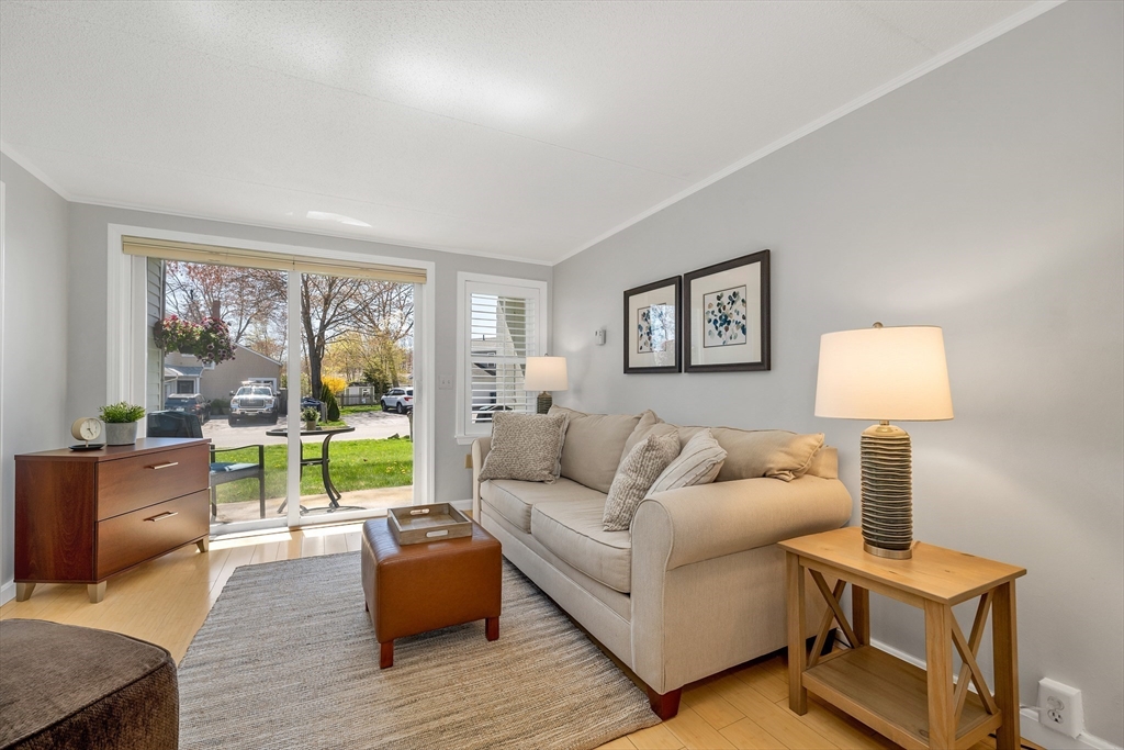 64 Esker Road, Unit 2 Hampton, NH 03842 - Photo 4 of 35 a living room with furniture and a large window