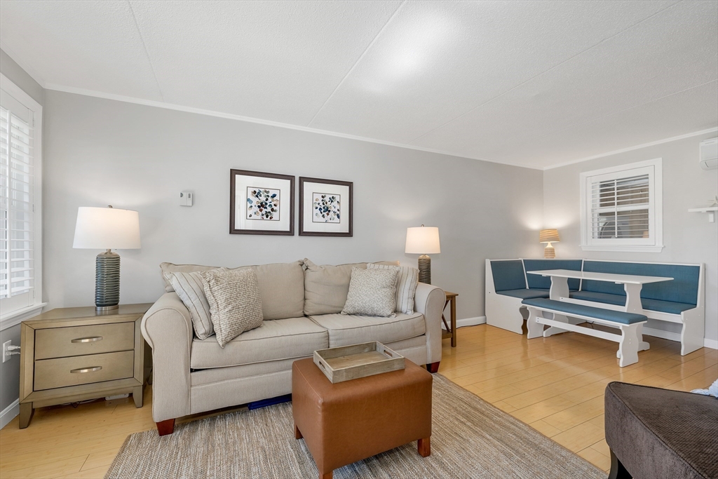 64 Esker Road, Unit 2 Hampton, NH 03842 - Photo 5 of 35 a living room with furniture and a lamp