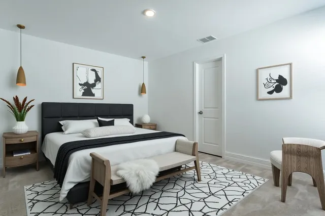 a bedroom with a bed and a chair