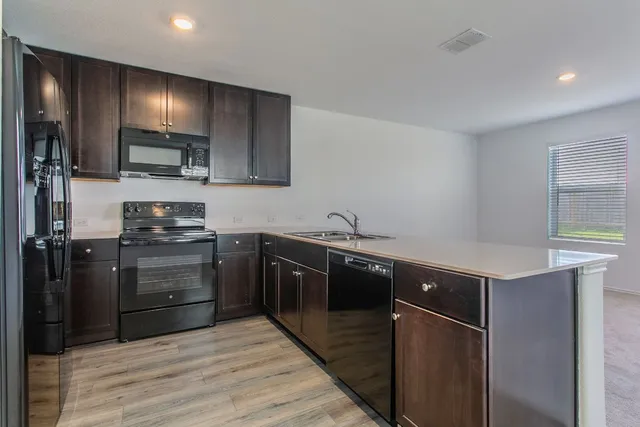 a kitchen with a sink and cabinets