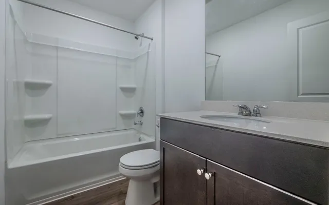 a bathroom with a sink toilet and a mirror