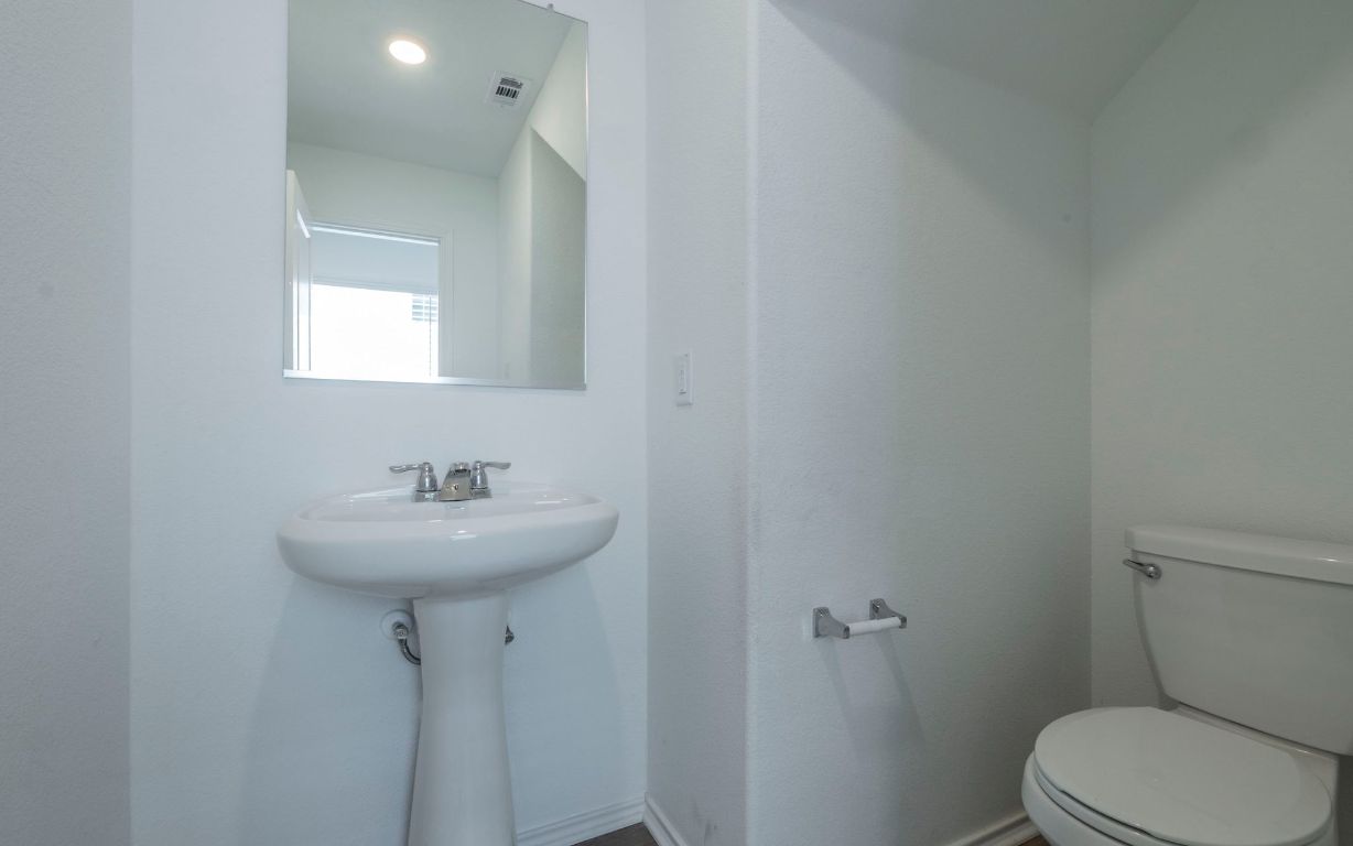 460 Marty Allen Loop Jarrell, TX 76537 - Photo 17 of 25 a bathroom with a sink toilet and a mirror
