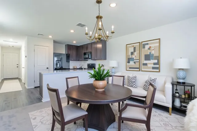 a view of a dining room with furniture and a chandelier