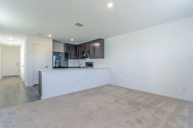 a view of kitchen and kitchen with window