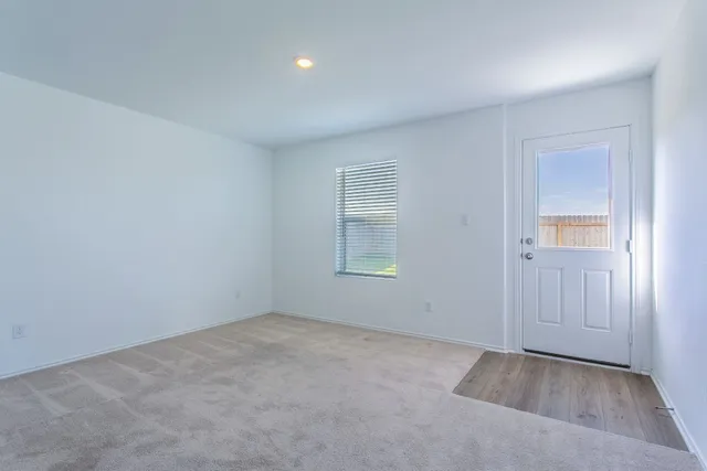 an empty room with windows and closet