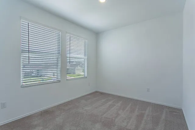a bedroom with furniture and a flat screen tv