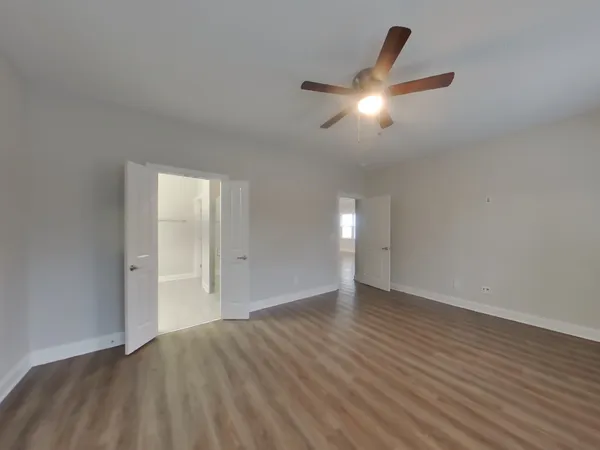 a view of empty room with wooden floor