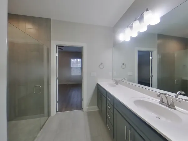 a bathroom with a sink a light fixture and a mirror
