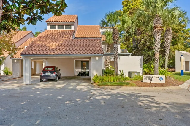 a view of a house with a patio and a yard