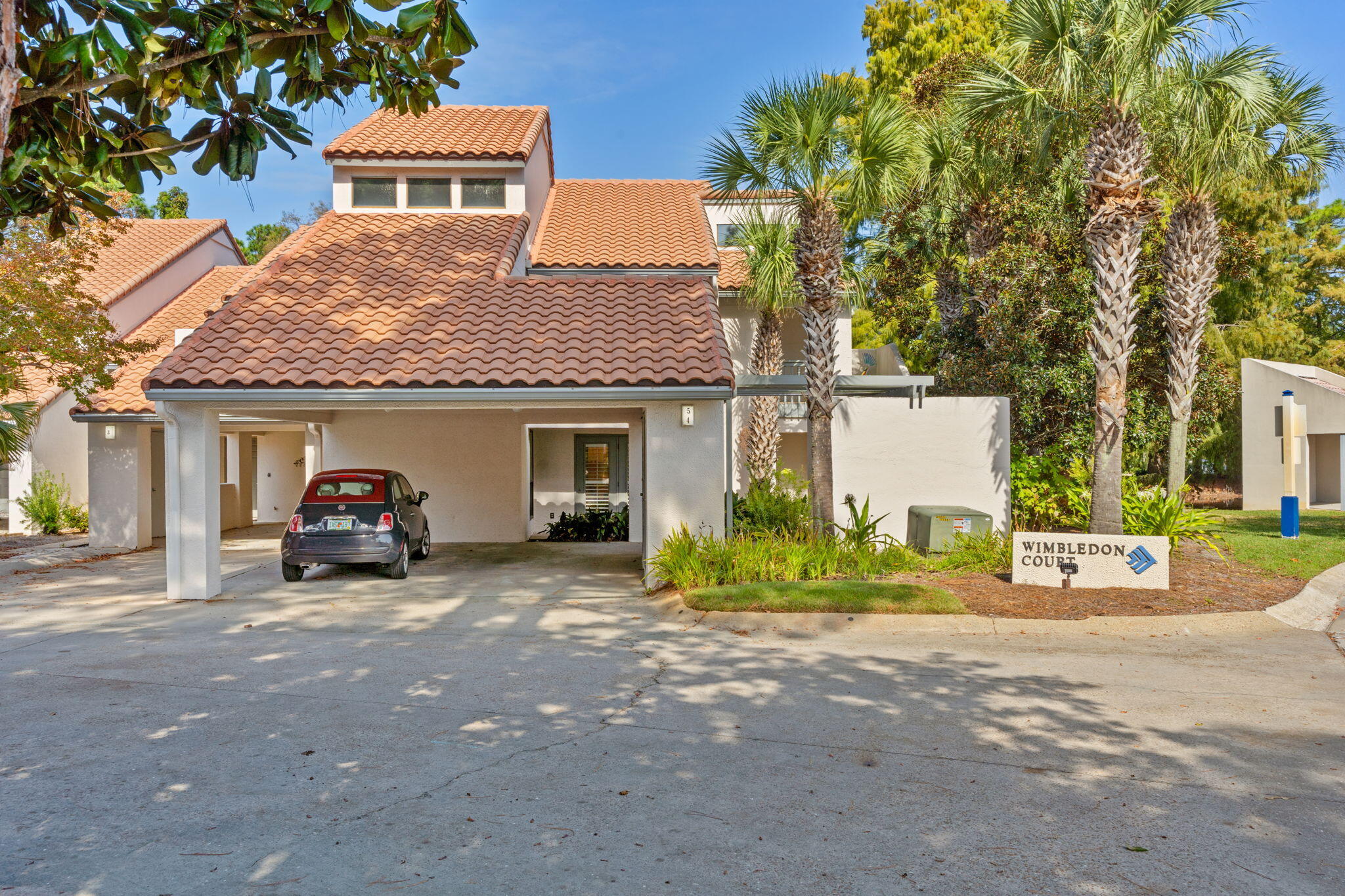 a view of a house with a patio and a yard