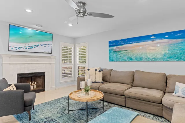 a living room with furniture a fireplace and a flat screen tv