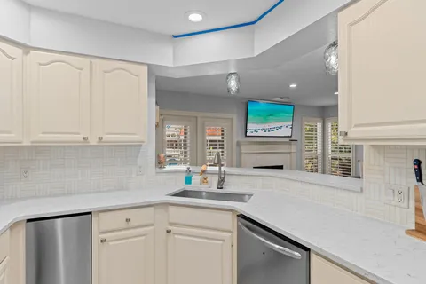 a kitchen with stainless steel appliances a sink stove and cabinets