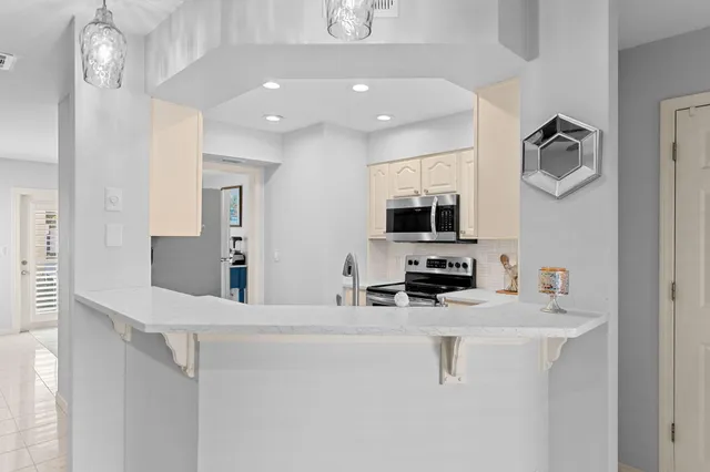 a kitchen with stainless steel appliances a sink and a refrigerator